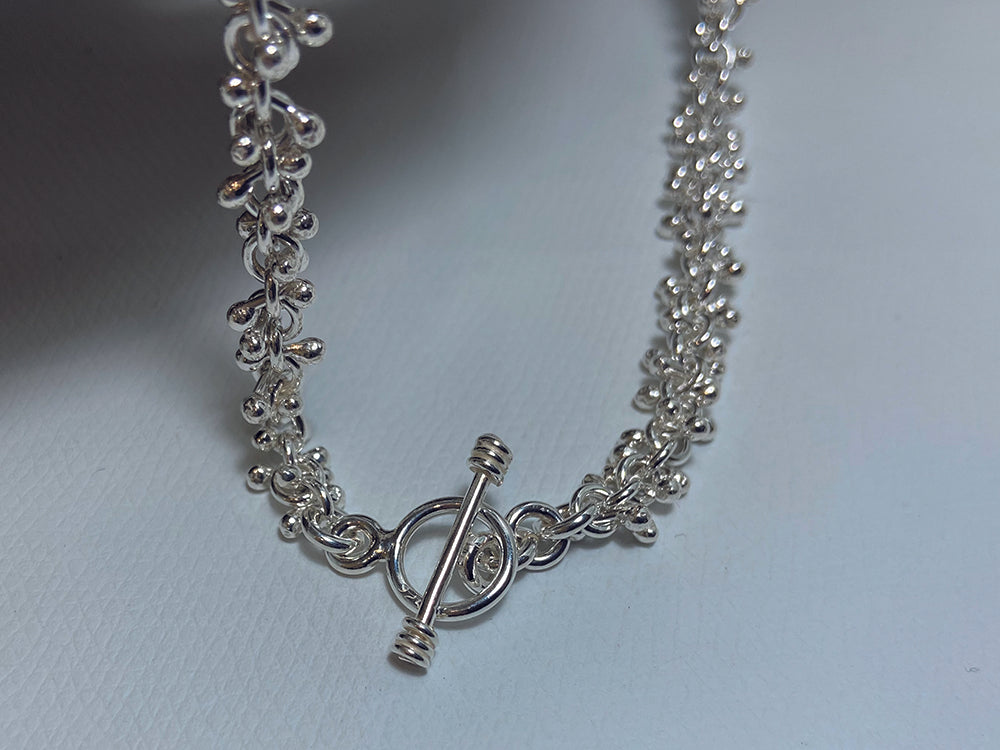 An unusual link, sterling silver necklace which has a lovely fluid feel. It is 18" long and weighs around 45 grams so carries a full set of UK Hallmarks. 925 Canterbury