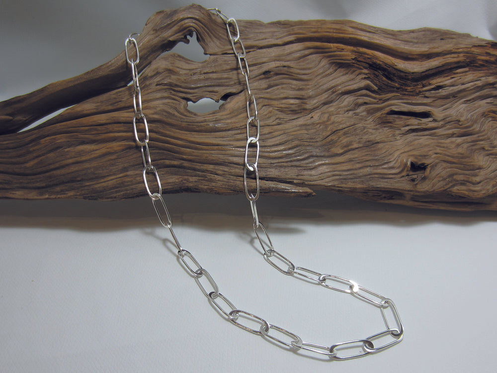 A nice flat link, sterling silver necklace which is 24" or 60cm long. Each link is 2cm long and the easy to use hook clasp can be attached to any link allowing the necklace to be worn at different lengths. The necklace weighs 19.5 grams and so carries a full set of Hallmarks. 925 Canterbury