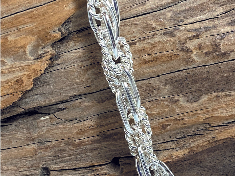 An unusual, sterling silver chain made up of interlinking plain and twisted links. The necklace is 18" long and weighs ajround 41 grams. 925 Silver, Canterbury