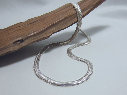 Slinky oval, sterling silver snake chain that is 16" or 41.5 cms long and 6.5mm wide, it weighs around 20 grams. 925 Canterbury