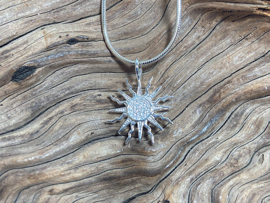 Eye catching sun design with microset cubic zirconia. The sterling silver pendant measures 20mm across. 925 Canterbury