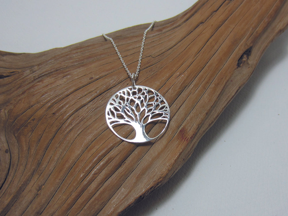 A bare branch, sterling silver tree of life pendant which measures 23mm across and comes complete with an 18"/46cm chain. 925 Canterbury